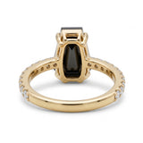 Black coffin-shaped gemstone engagement ring with four polished prongs and round clear accents along a white-metal band