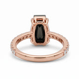Black coffin-shaped gemstone engagement ring with four polished prongs and round clear accents along a white-metal band