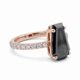 Black coffin-shaped gemstone engagement ring with four polished prongs and round clear accents along a white-metal band