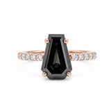 Black coffin-shaped gemstone engagement ring with four polished prongs and round clear accents along a white-metal band