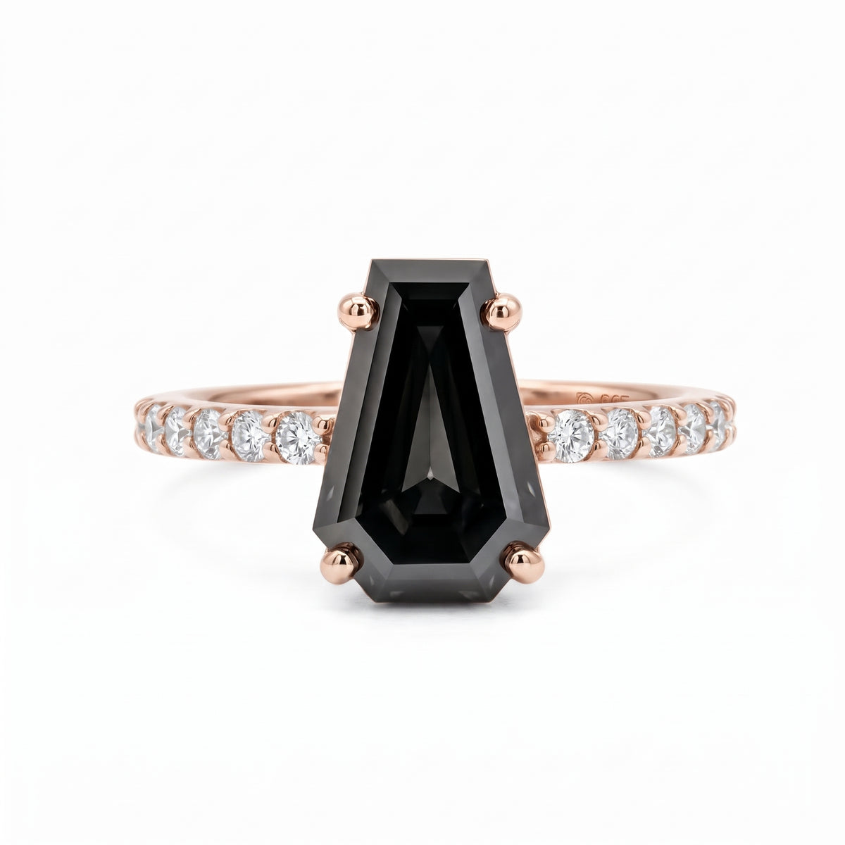 Black coffin-shaped gemstone engagement ring with four polished prongs and round clear accents along a white-metal band