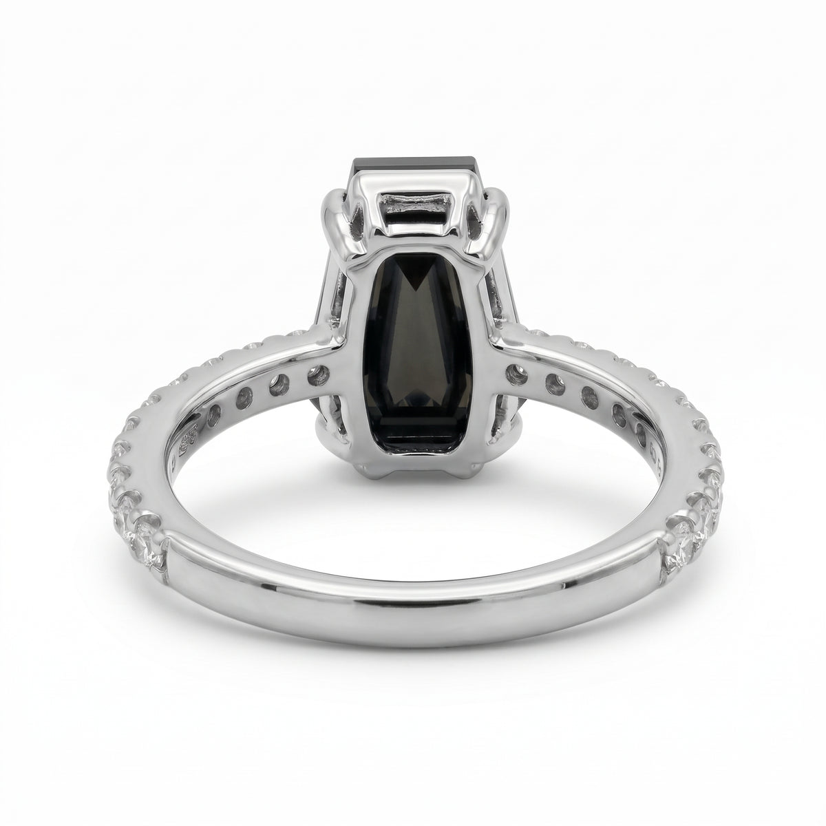 Black coffin-shaped gemstone engagement ring with four polished prongs and round clear accents along a white-metal band