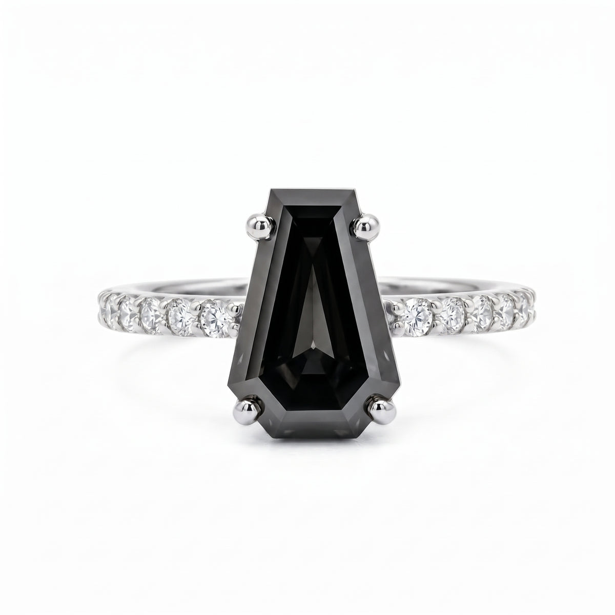 Black coffin-shaped gemstone engagement ring with four polished prongs and round clear accents along a white-metal band