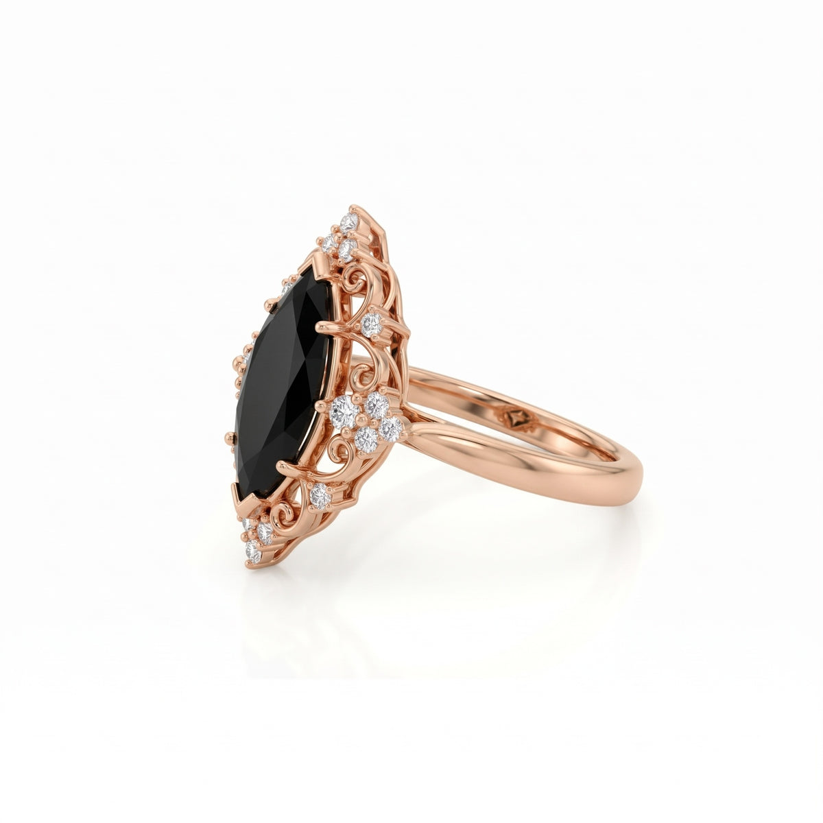 Black marquise gemstone ring with ornate white-metal scrollwork, clear round accent clusters and a polished band