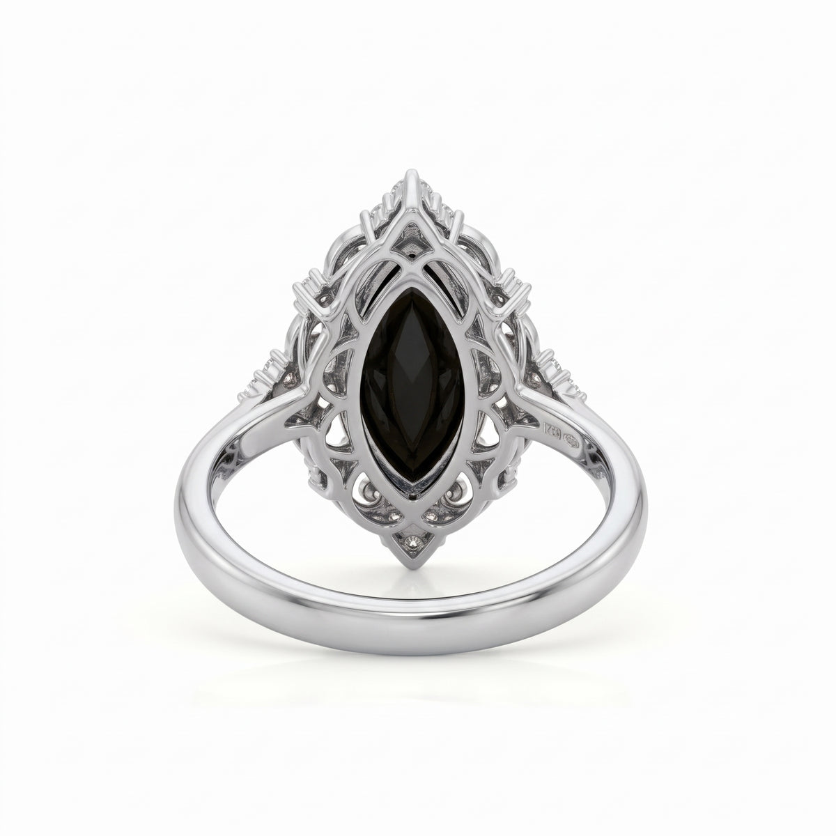 Black marquise gemstone ring with ornate white-metal scrollwork, clear round accent clusters and a polished band
