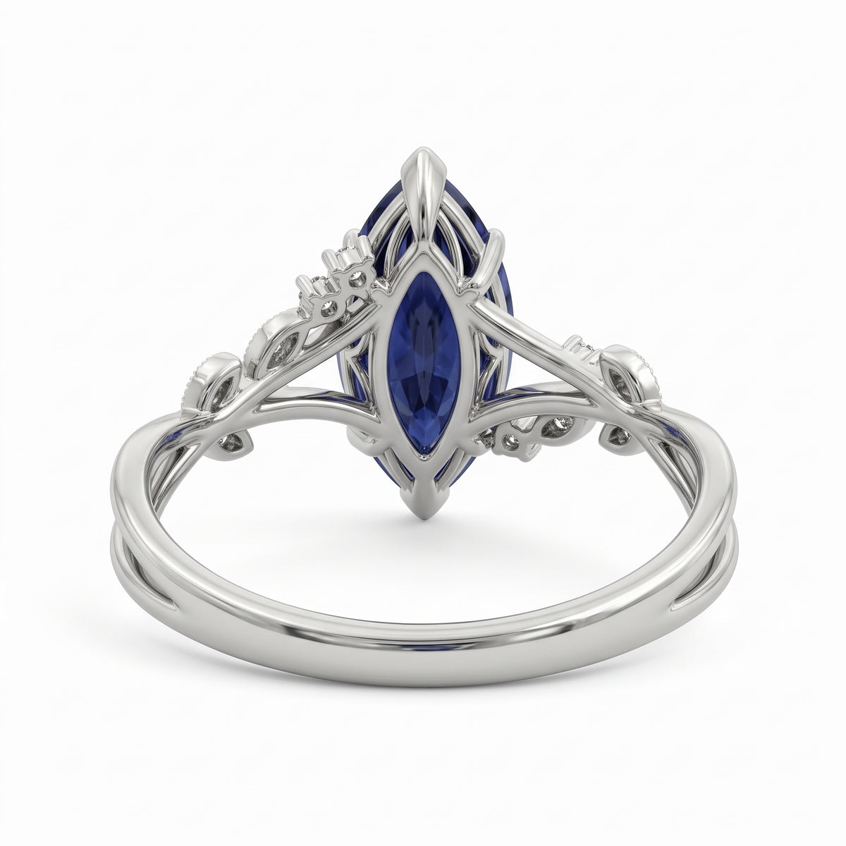 Deep-blue marquise gemstone ring with white-metal split shoulders, sparkling leaf-shaped settings and scattered round accents