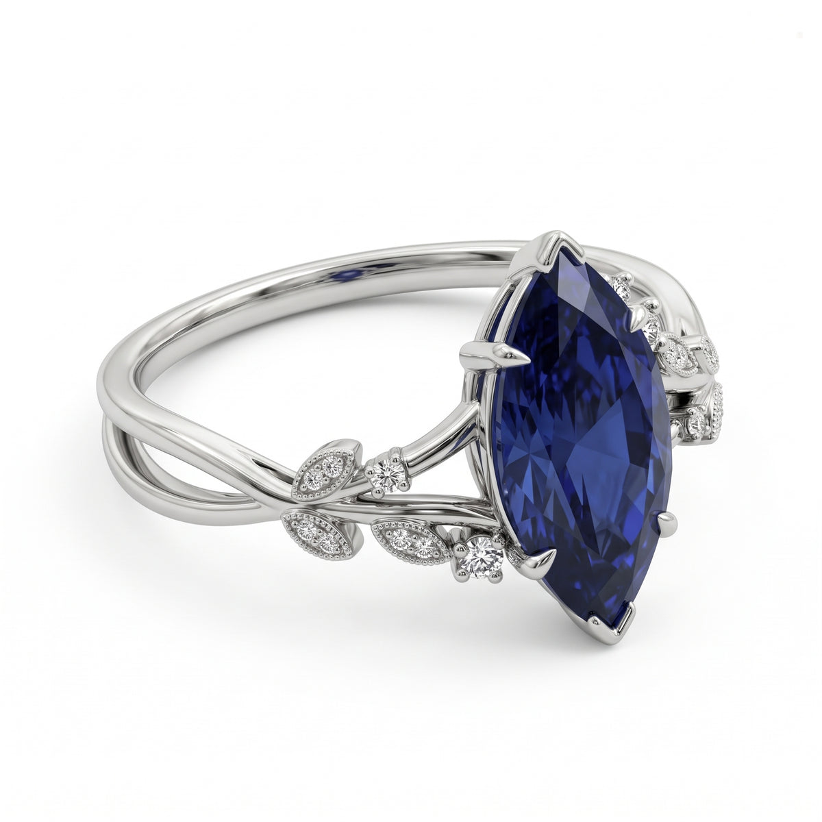 Deep-blue marquise gemstone ring with white-metal split shoulders, sparkling leaf-shaped settings and scattered round accents