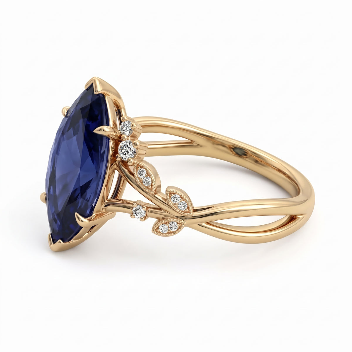 Deep-blue marquise gemstone ring with white-metal split shoulders, sparkling leaf-shaped settings and scattered round accents