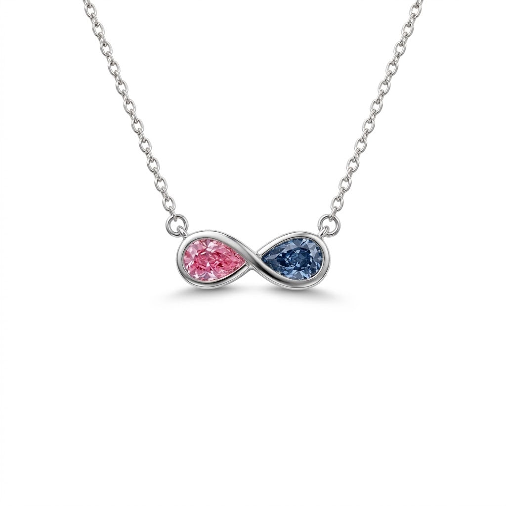Discover a pink and blue pear-cut infinity pendant with smooth bezel settings. Personalize your gemstone pairing and metal with Gemlux Jewels.