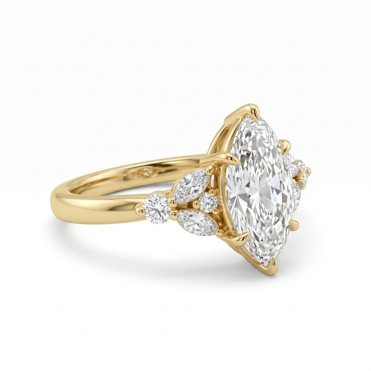 A yellow gold ring featuring a marquise-cut diamond center stone with smaller round and marquise diamonds on the shoulders, set against a clean white background.