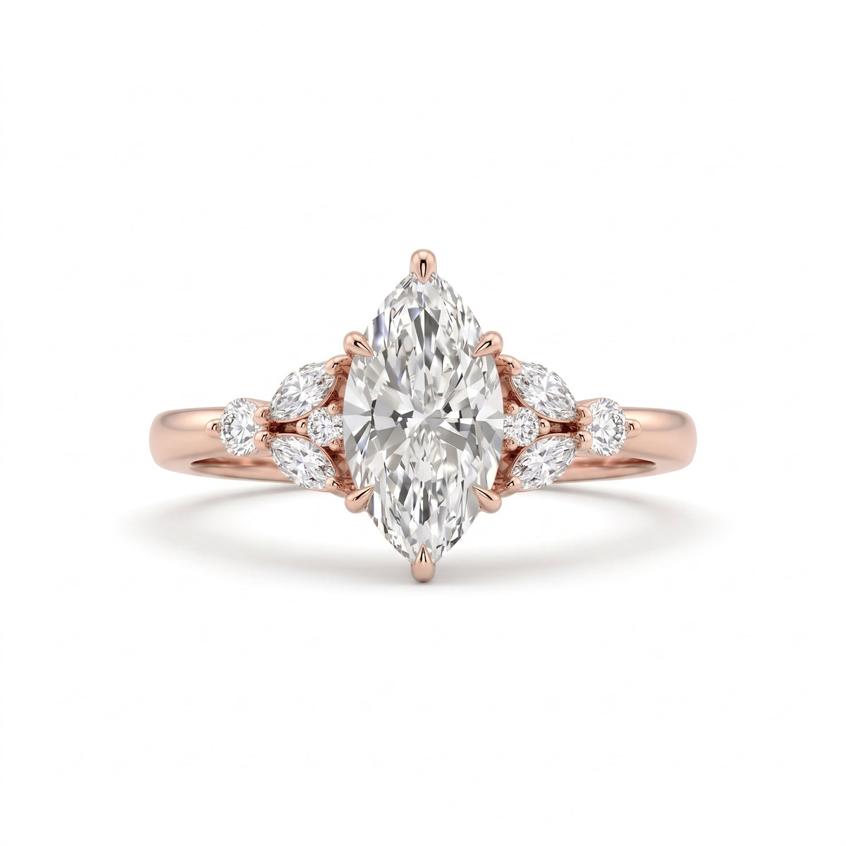 A rose gold engagement ring featuring a marquise-cut center diamond surrounded by smaller round and marquise diamonds on the band, set against a clean white background.