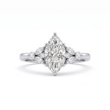A silver-toned diamond ring featuring a marquise-cut center stone with smaller diamond accents on the shoulders, set against a clean white background.