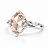 Oval rose-cut lab-grown diamond solitaire engagement ring with a four-prong compass setting and sculpted white-metal band