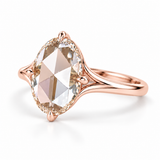 Oval rose-cut lab-grown diamond solitaire engagement ring with a four-prong compass setting and sculpted white-metal band
