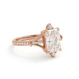 Radiant-cut engagement ring with pear-shaped accents above and below the center stone, pavé diamonds and polished white-metal split shoulders