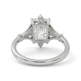 Radiant-cut engagement ring with pear-shaped accents above and below the center stone, pavé diamonds and polished white-metal split shoulders