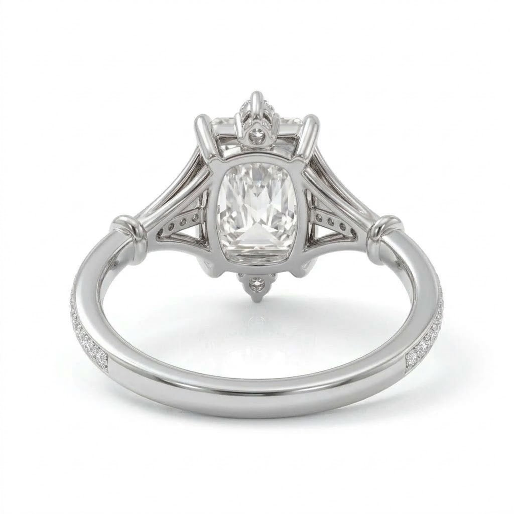 Radiant-cut engagement ring with pear-shaped accents above and below the center stone, pavé diamonds and polished white-metal split shoulders