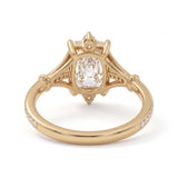 Radiant-cut engagement ring with pear-shaped accents above and below the center stone, pavé diamonds and polished white-metal split shoulders