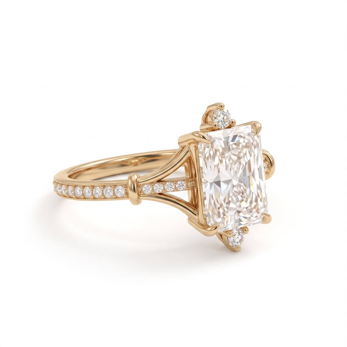 Radiant-cut engagement ring with pear-shaped accents above and below the center stone, pavé diamonds and polished white-metal split shoulders