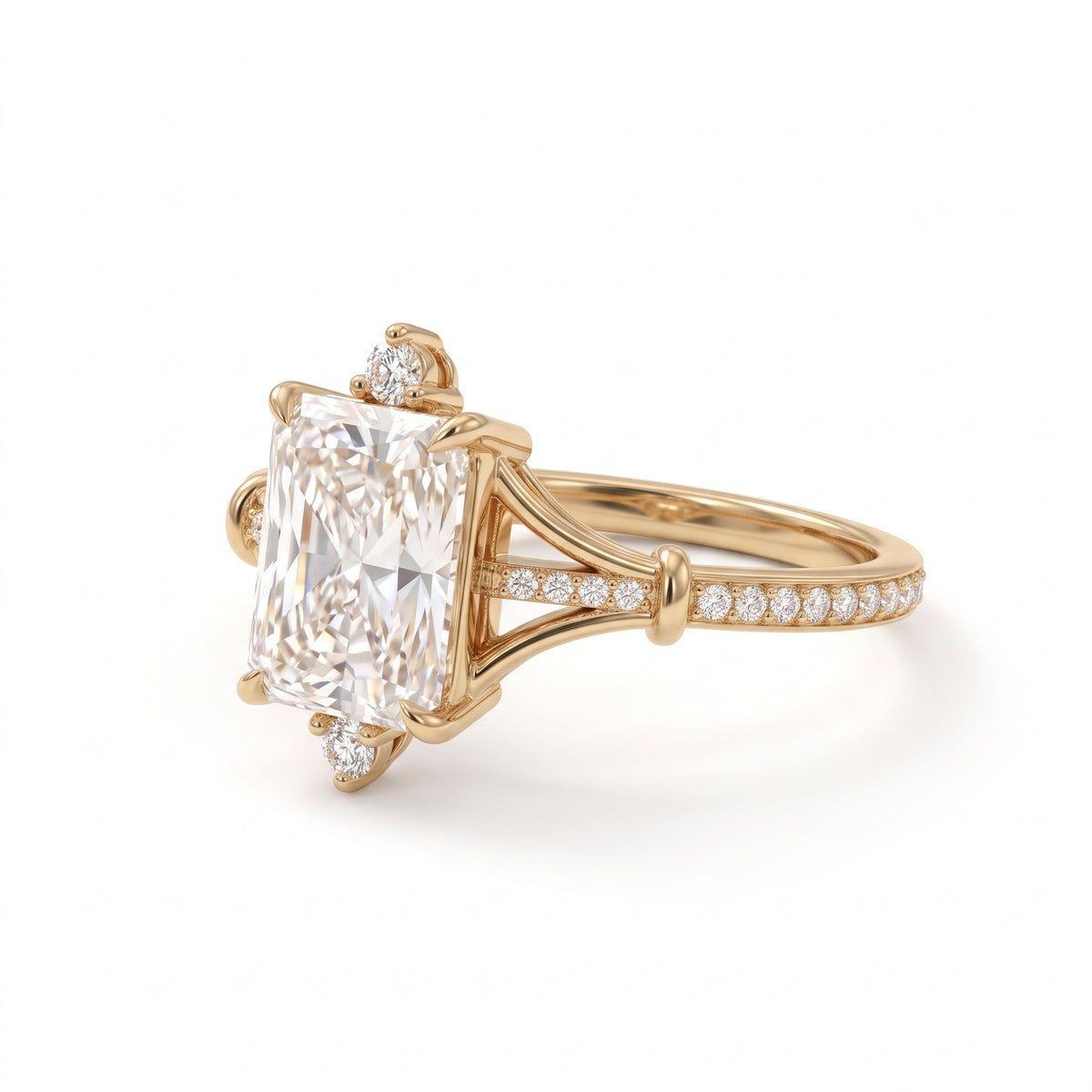Radiant-cut engagement ring with pear-shaped accents above and below the center stone, pavé diamonds and polished white-metal split shoulders