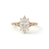 Radiant-cut engagement ring with pear-shaped accents above and below the center stone, pavé diamonds and polished white-metal split shoulders