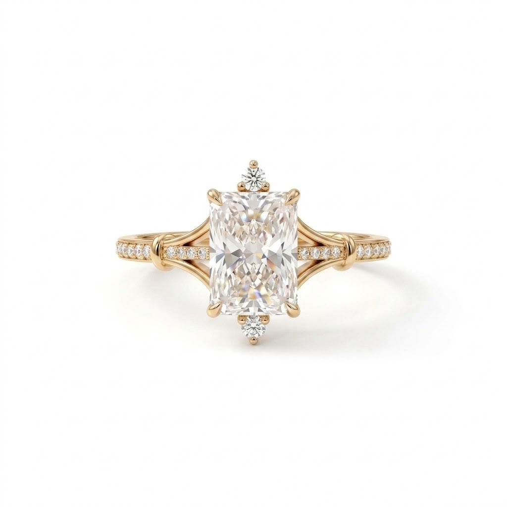 Radiant-cut engagement ring with pear-shaped accents above and below the center stone, pavé diamonds and polished white-metal split shoulders