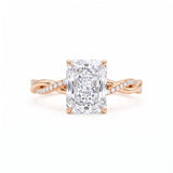 Radiant-cut engagement ring with four claw prongs and a twisted white-metal band combining polished and pavé-set strands