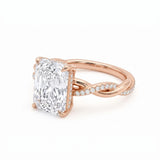 Radiant-cut engagement ring with four claw prongs and a twisted white-metal band combining polished and pavé-set strands