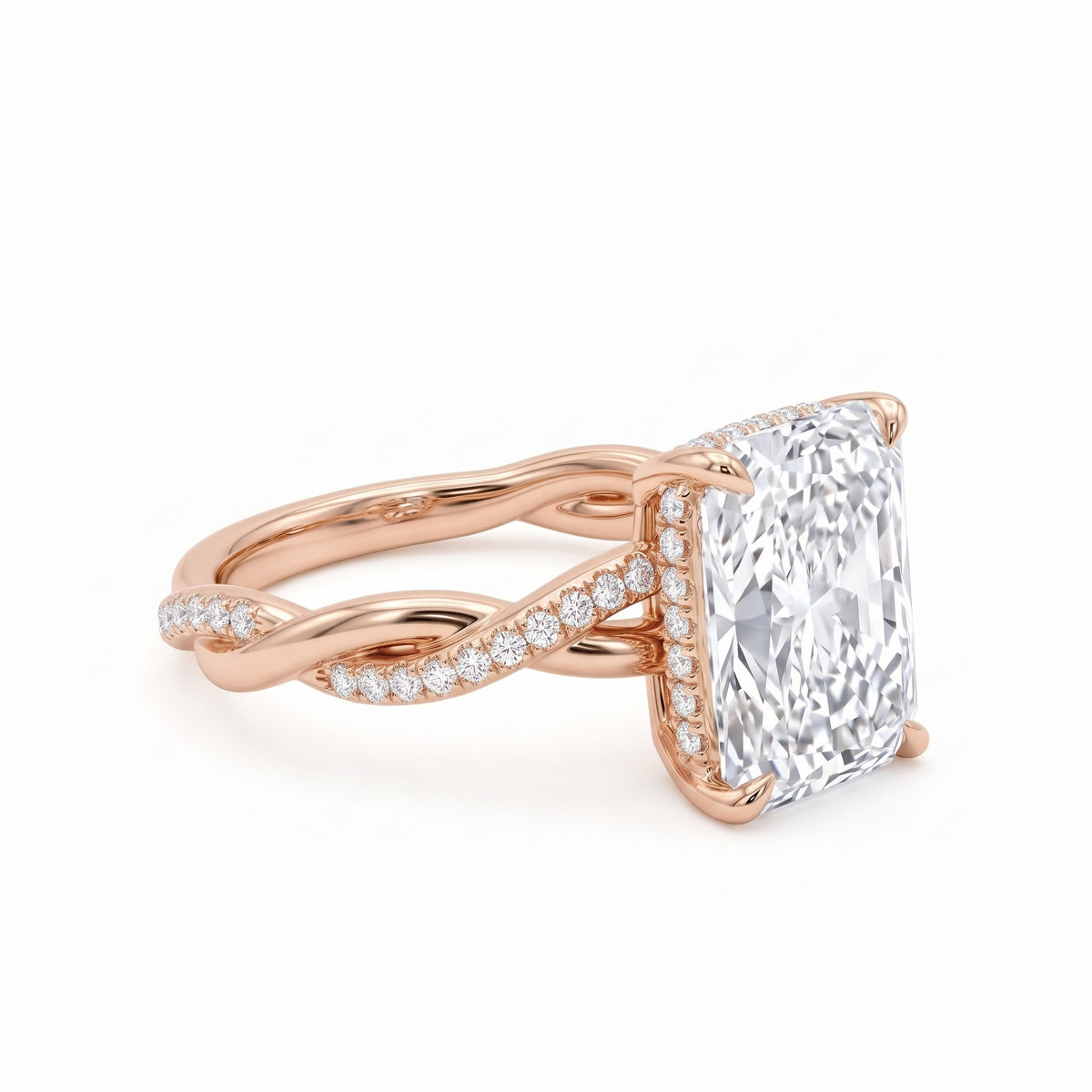 Radiant-cut engagement ring with four claw prongs and a twisted white-metal band combining polished and pavé-set strands