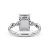 Radiant-cut engagement ring with four claw prongs and a twisted white-metal band combining polished and pavé-set strands