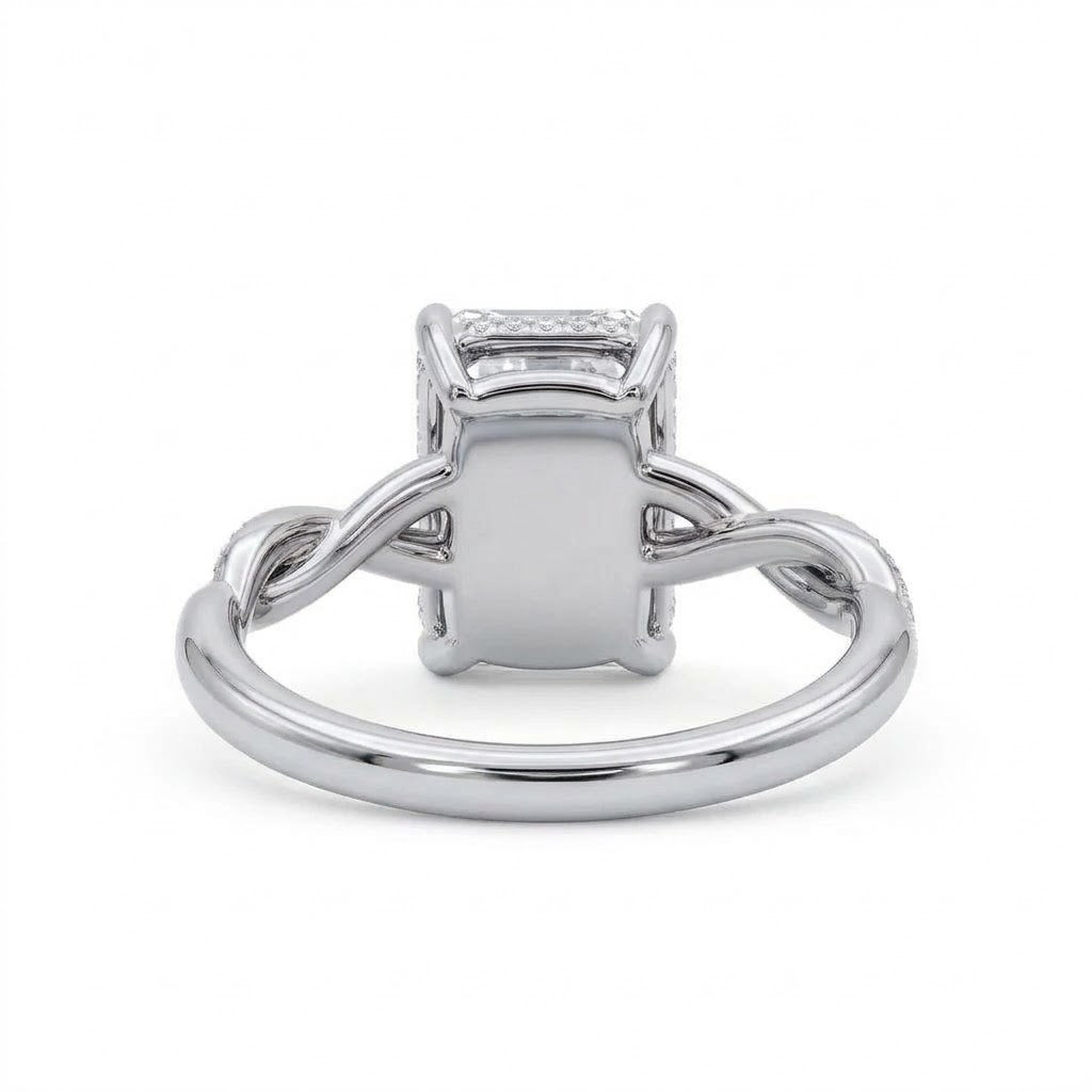 Radiant-cut engagement ring with four claw prongs and a twisted white-metal band combining polished and pavé-set strands