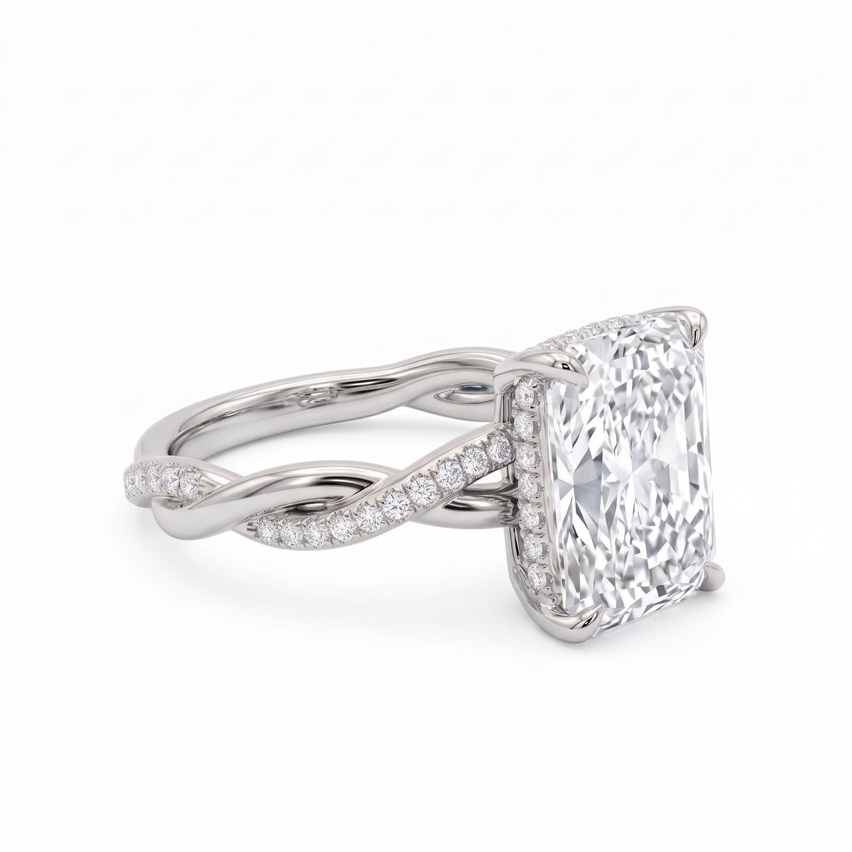 Radiant-cut engagement ring with four claw prongs and a twisted white-metal band combining polished and pavé-set strands