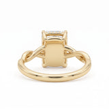 Radiant-cut engagement ring with four claw prongs and a twisted white-metal band combining polished and pavé-set strands