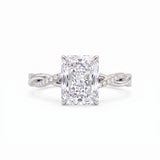Radiant-cut engagement ring with four claw prongs and a twisted white-metal band combining polished and pavé-set strands