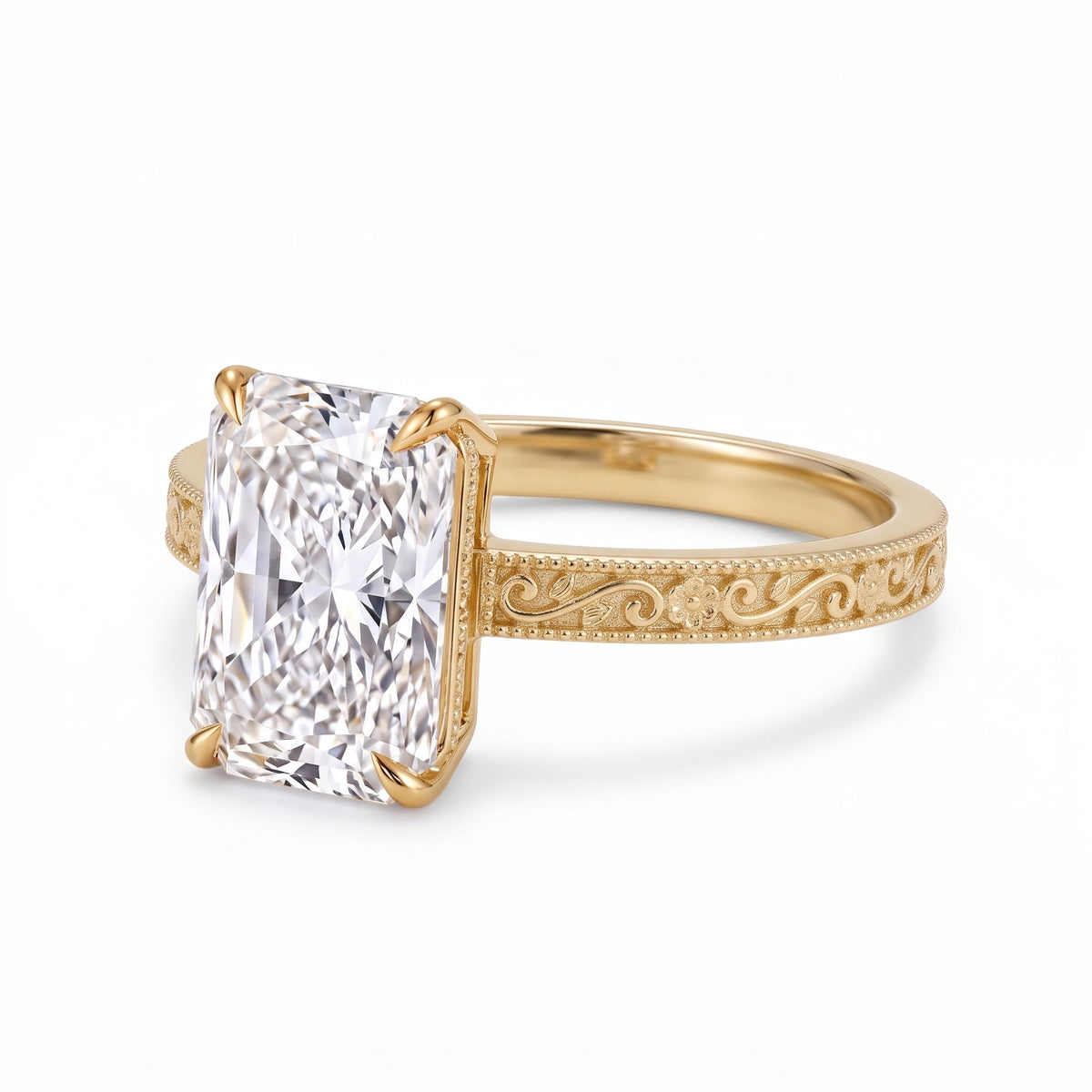Radiant-cut solitaire engagement ring with four claw prongs, floral scroll engravings and milgrain borders on a white-metal band