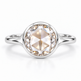 Round rose-cut lab-grown diamond solitaire ring with a smooth bezel setting and sculpted polished white-metal band