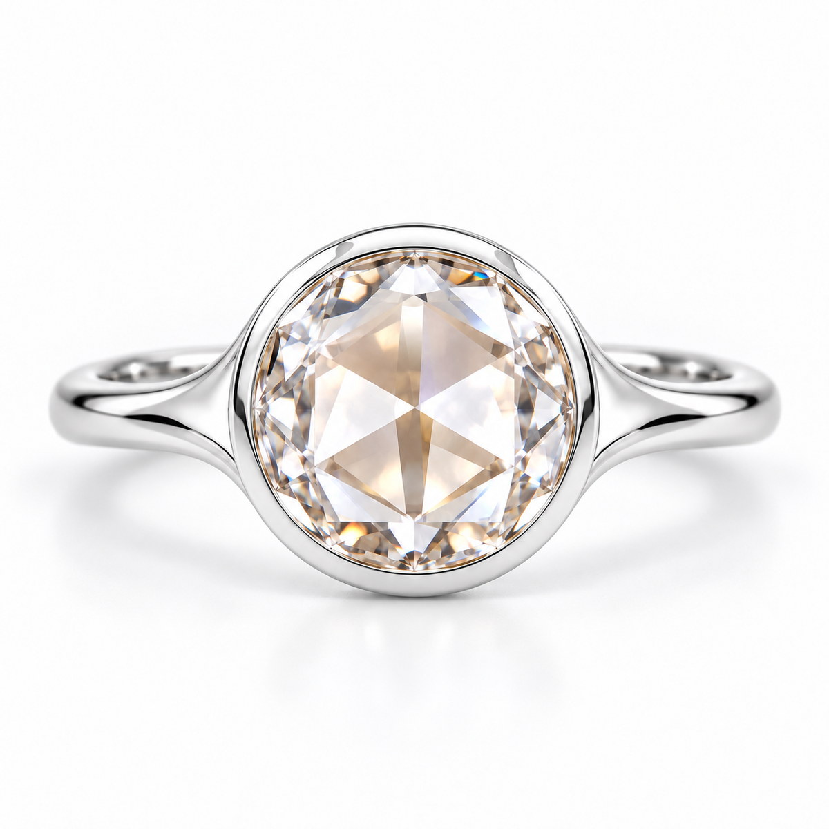 Round rose-cut lab-grown diamond solitaire ring with a smooth bezel setting and sculpted polished white-metal band