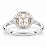 Round rose-cut lab-grown diamond solitaire ring with a smooth bezel setting and sculpted polished white-metal band