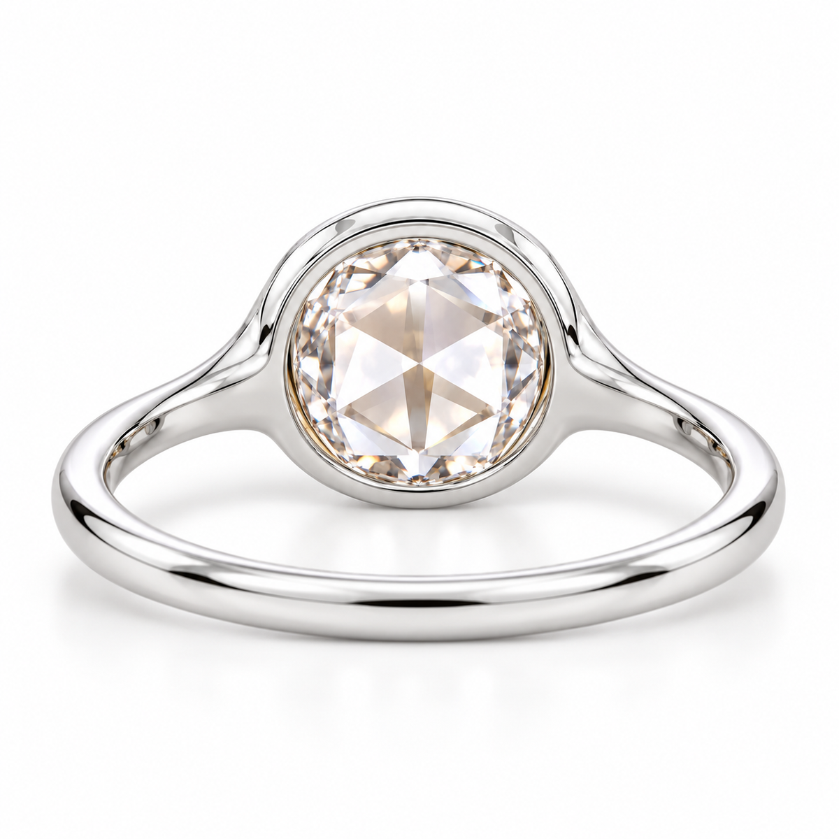 Round rose-cut lab-grown diamond solitaire ring with a smooth bezel setting and sculpted polished white-metal band