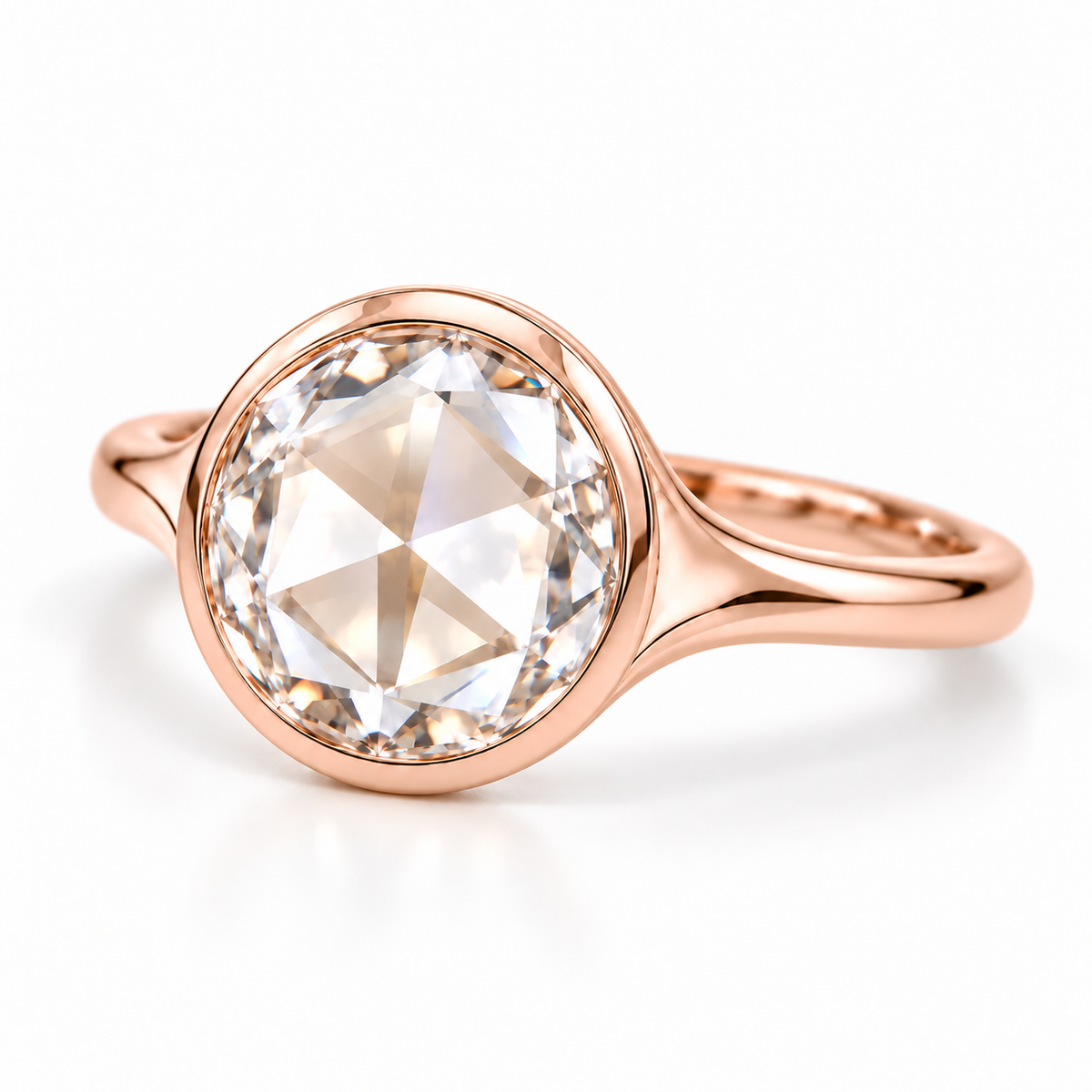 Round rose-cut lab-grown diamond solitaire ring with a smooth bezel setting and sculpted polished white-metal band