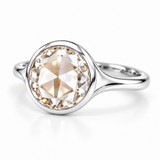 Round rose-cut lab-grown diamond solitaire ring with a smooth bezel setting and sculpted polished white-metal band
