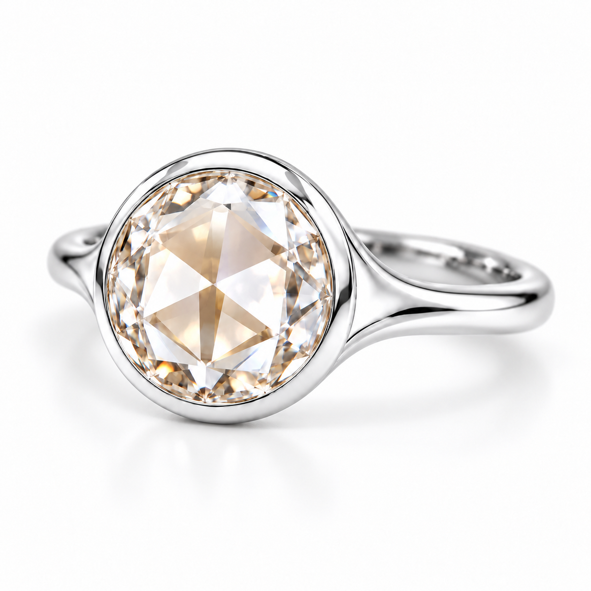 Round rose-cut lab-grown diamond solitaire ring with a smooth bezel setting and sculpted polished white-metal band